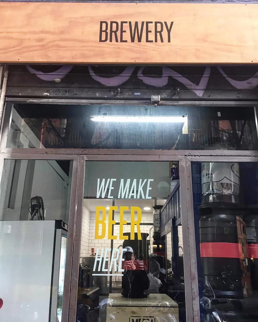 Archive photograph of a storefront brewery sign in Barcelona · 2018
